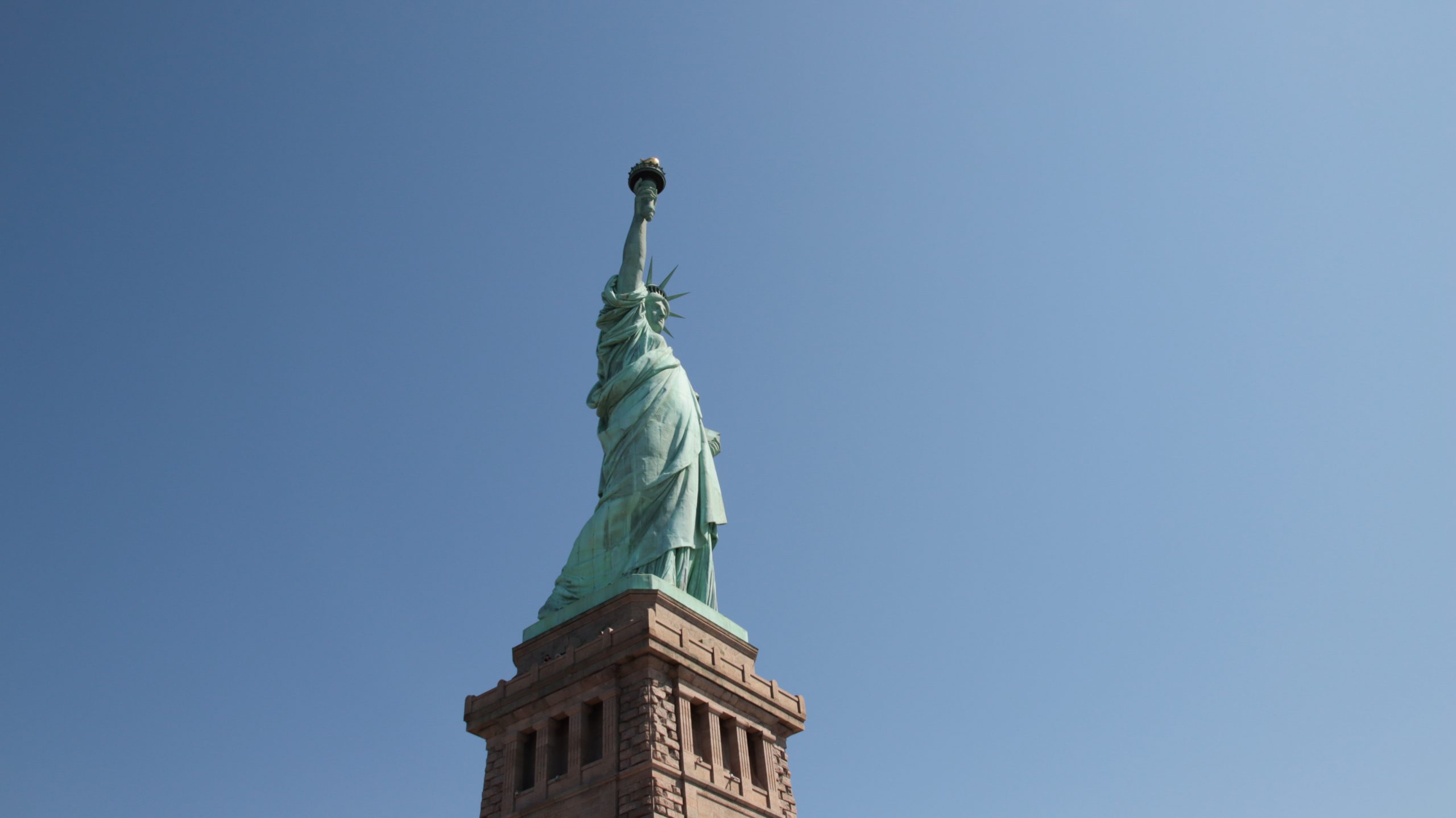 Low angle side shot of Statue of Liberty in the daytime